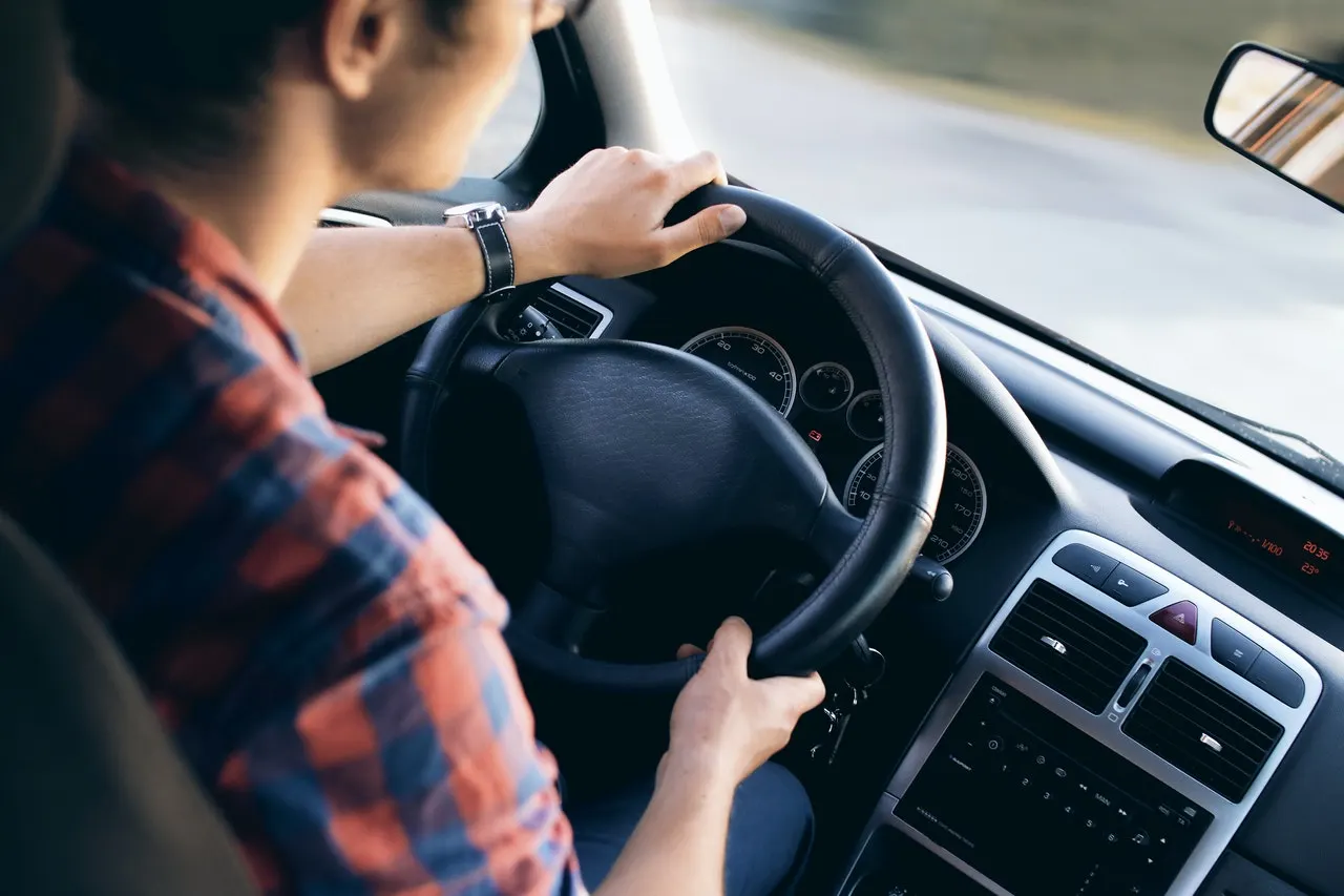 Young man driving car